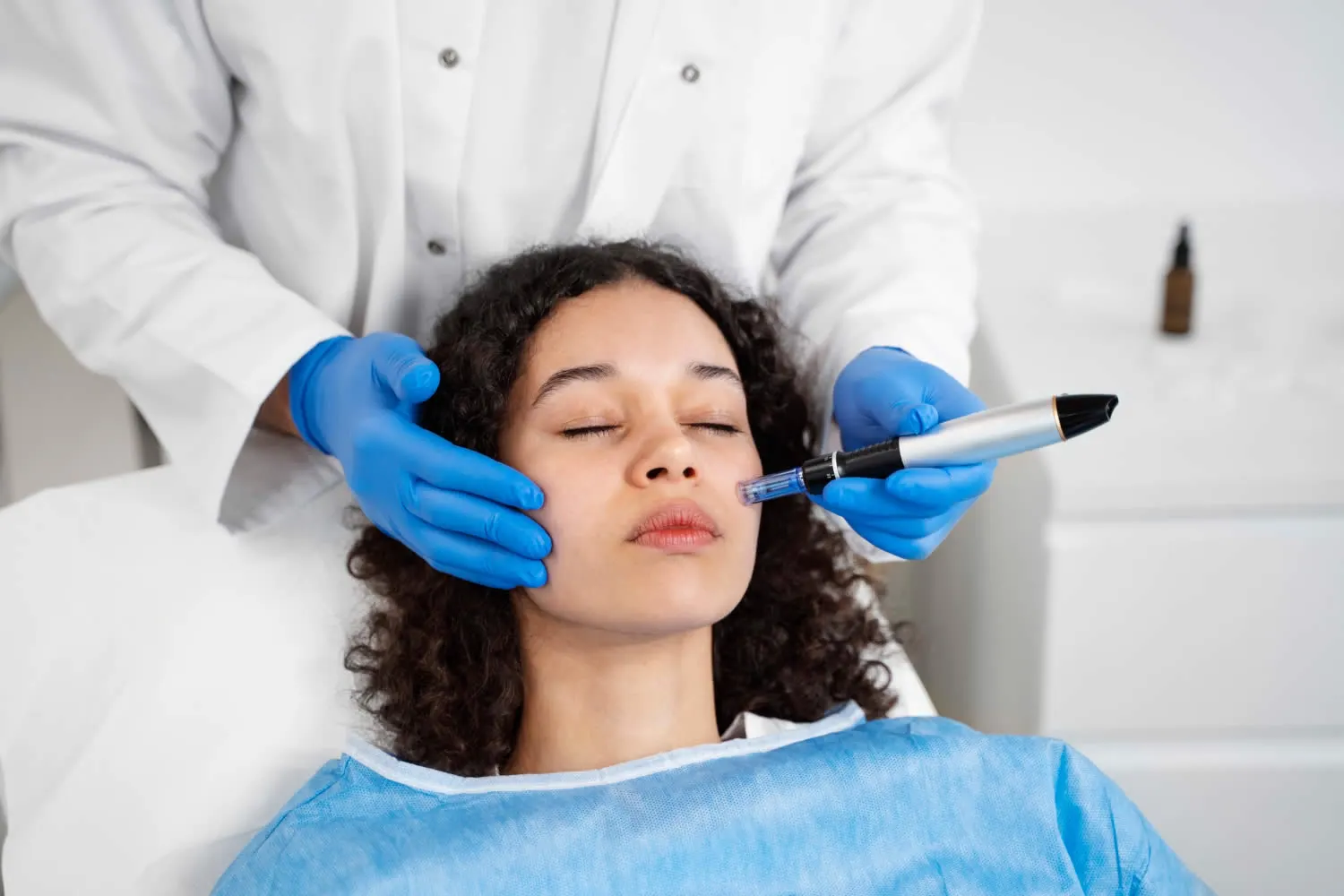 medical dermatology woman patient-undergoing-microneedling-dermatologist